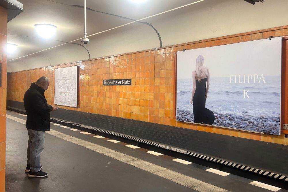 A large billboard at Rosenthaler Platz subway station. The billboard advertises the Filippa K brand.