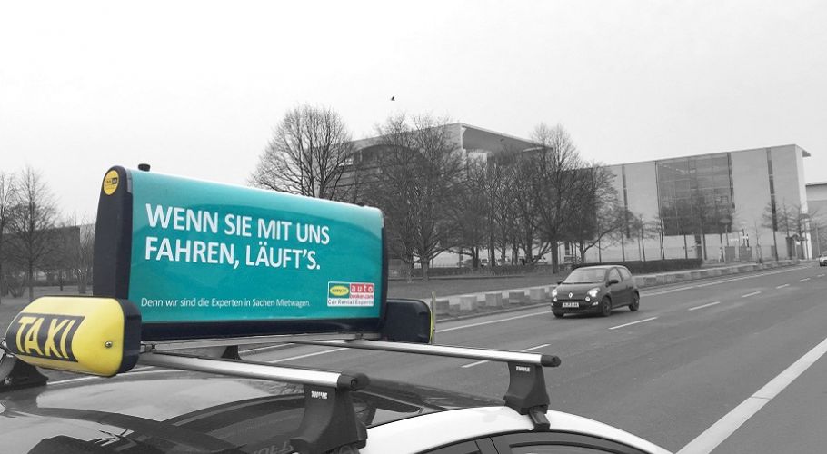 A sign on a cab in Berlin showing the Sunnycars advertisement.